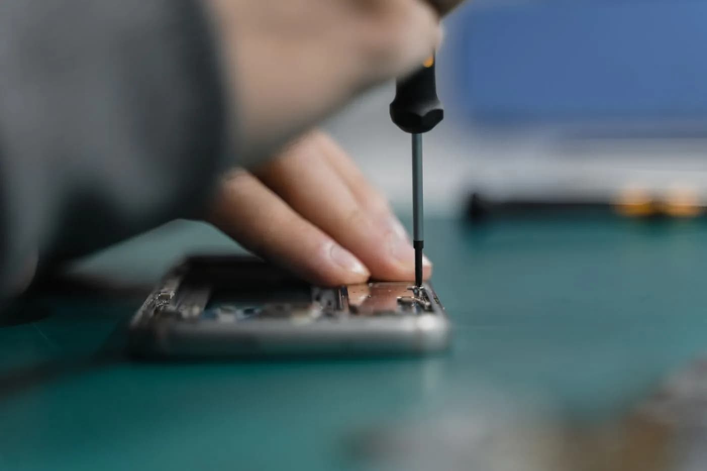 NZ Tech Repairs technician working on a device for a customer from Millwater