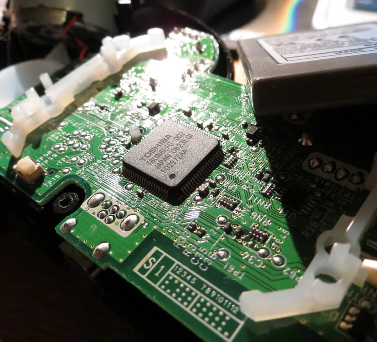 Micro-soldering an HDMI port on a console board at NZ Tech Repairs Warkworth